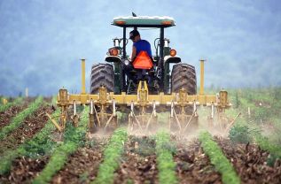 800px-farmer_and_tractor_tilling_soil
